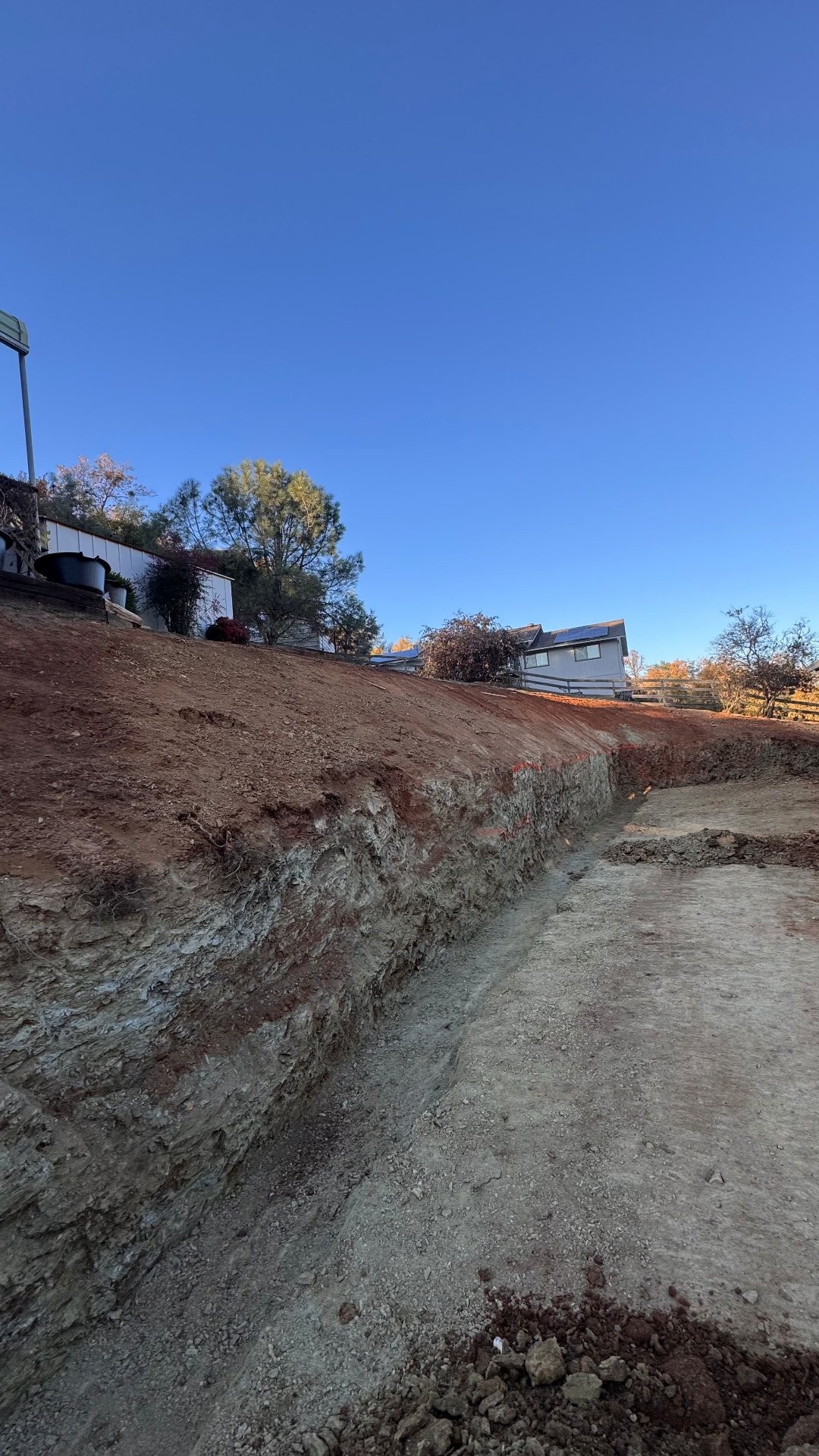 Hillside cut and driveway excavation on a residential property
