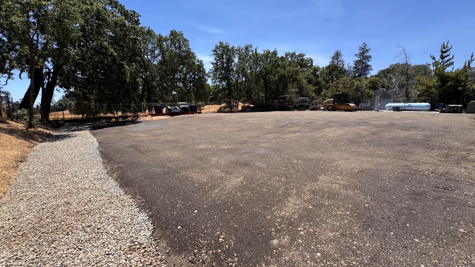 Compacted base rock parking lot graded and rolled on a wooded property
